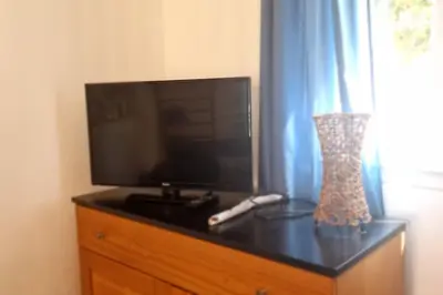 a flat screen tv sitting on top of a dresser at Villa La Casa de Giuseppe in Cervione