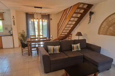 a living room with a couch and a dining room at Villa La Casa de Giuseppe in Cervione