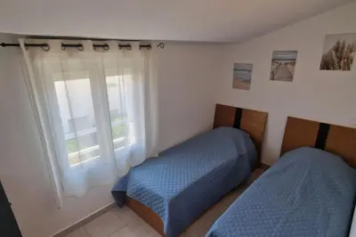 a bedroom with two beds and a window at Villa La Casa de Giuseppe in Cervione