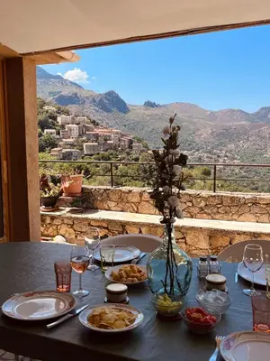 a table with plates of food and glasses of wine at Casa Orsini in Nessa