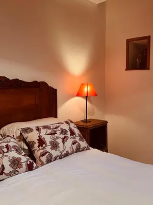 a bedroom with a bed with a lamp on a night stand at Casa Orsini in Nessa