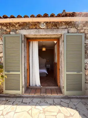 a door leading to a bedroom with a bed at Casa Orsini in Nessa