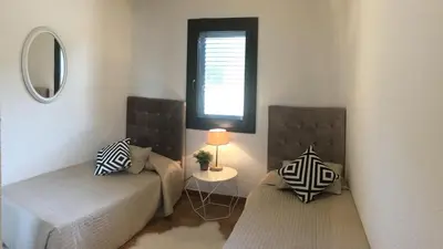 a small room with two beds and a window at Residence Bellavista à Santa Giulia, proche de la plage et vue mer in Porto-Vecchio