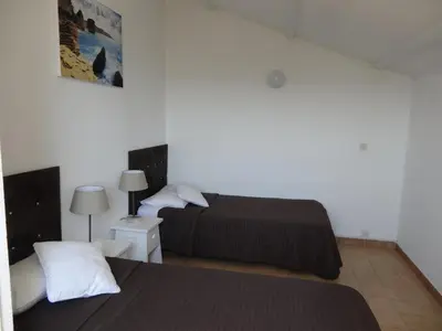 a hotel room with two beds and a lamp at Residence Bellavista à Santa Giulia, proche de la plage et vue mer in Porto-Vecchio