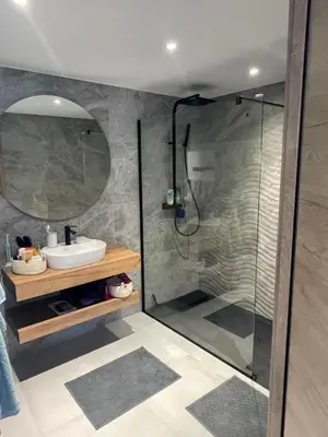 a bathroom with a shower with a sink and a mirror at Le Galatee -T2 luxe les pieds dans l'eau - Porticcio in Porticcio