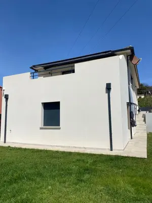 a white house with a black roof at Terra bella Costa Verde T2 classé 3 étoiles in San-Nicolao