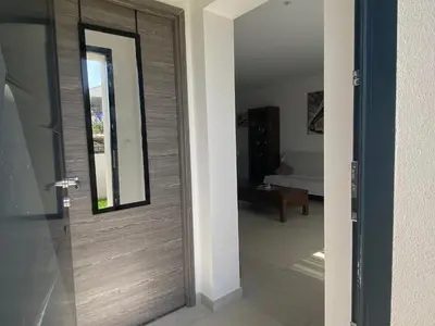 a wooden door in a room with a bedroom at Terra bella Costa Verde T2 classé 3 étoiles in San-Nicolao
