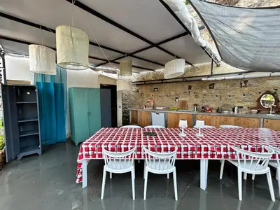 a dining room with a red and white table and chairs at Corse entre mer et montagne in Lavatoggio