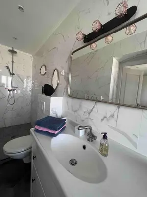 a bathroom with a sink and a toilet and a mirror at Corse entre mer et montagne in Lavatoggio
