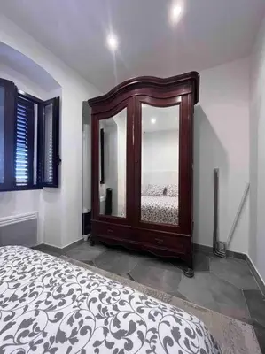 a bedroom with a bed and a large window at Corse entre mer et montagne in Lavatoggio