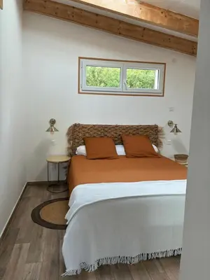 a bedroom with a bed and a window at Petite maison avec terrasse. in Ajaccio
