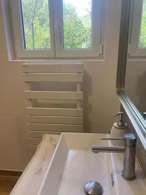 a bathroom with a sink and a mirror at Petite maison avec terrasse. in Ajaccio