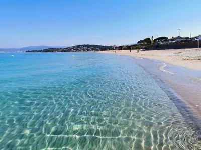 a beach with clear blue water and a sandy shore at Studio 150 m de la plage Agosta in Albitreccia