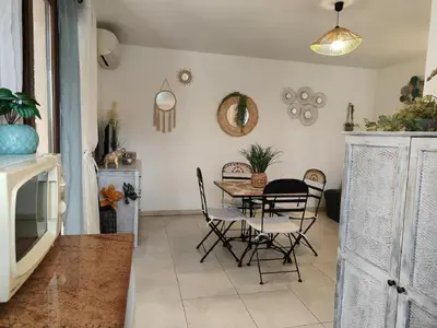 a dining room with a table and chairs at Studio 150 m de la plage Agosta in Albitreccia