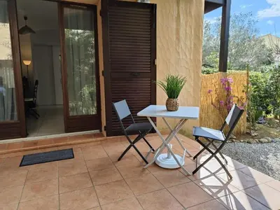a table and chairs sitting on a patio at Studio 150 m de la plage Agosta in Albitreccia