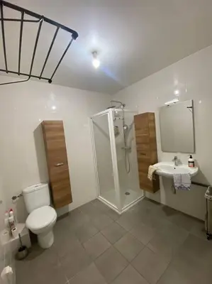 a bathroom with a toilet and a shower and a sink at Appartement cosy climatisé dans résidence fermée in Sarrola-Carcopino