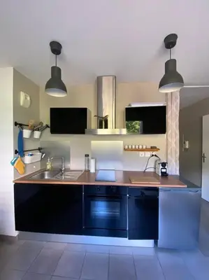 a kitchen with a sink and a counter top at Appartement cosy climatisé dans résidence fermée in Sarrola-Carcopino