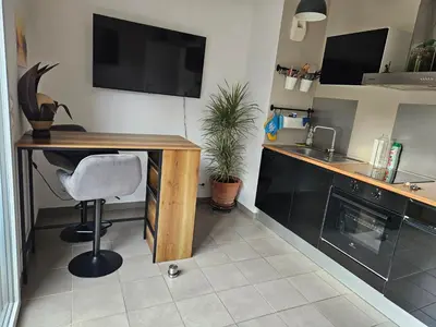 a kitchen with a desk with a chair and a sink at Appartement cosy climatisé dans résidence fermée in Sarrola-Carcopino