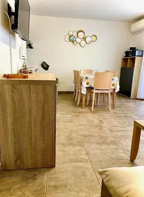 a kitchen and dining room with a table and chairs at Villa Noelly - Résidence les Hauts de Bonifacio in Bonifacio