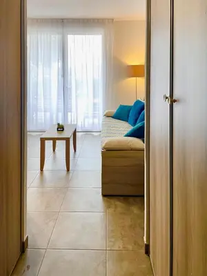 a living room with a couch and a table at Villa Noelly - Résidence les Hauts de Bonifacio in Bonifacio