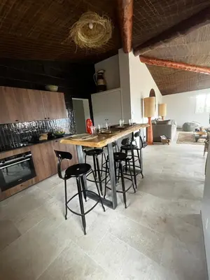a kitchen with a large wooden table and chairs at Villa LILY BAY baie de Santa Giulia-Porto Vecchio in Porto-Vecchio