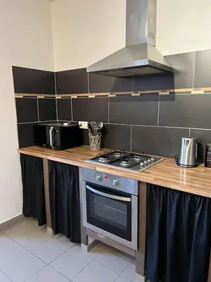 a kitchen with a stove and a counter top at Appartement 90 m2 proche de Corte in Soveria
