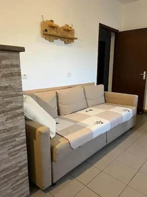 a large couch sitting in a room at Appartement 90 m2 proche de Corte in Soveria