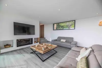 a living room with a couch and a table at Ivona Vacances - Villa de luxe avec piscine chauffée à Santa-Giulia in Porto-Vecchio