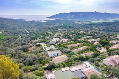 an aerial view of a small village with trees and houses at Ivona Vacances - Villa de luxe avec piscine chauffée à Santa-Giulia in Porto-Vecchio