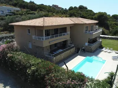 an aerial view of a house with a swimming pool at Appartement avec piscine à 50 m de la plage in Propriano