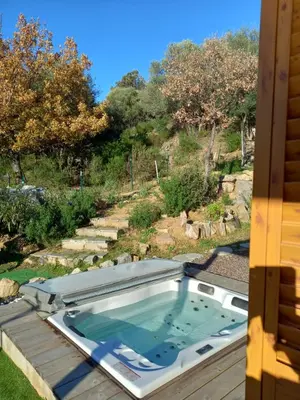 a hot tub on the roof of a house at Maison neuve Vue imprenable Piscine et spa in Calenzana