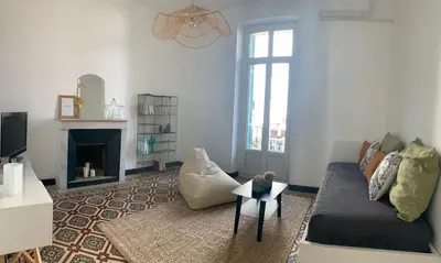 a living room with a couch and a fireplace at Superbe appartement centre ville Ajaccio in Ajaccio