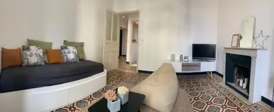 a living room with a couch and a fireplace at Superbe appartement centre ville Ajaccio in Ajaccio