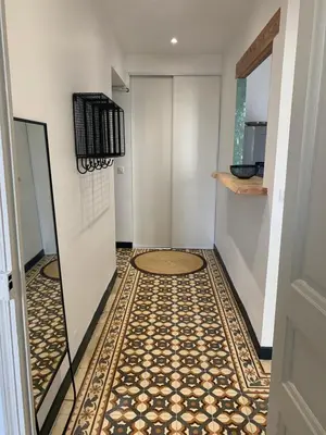 a hallway with a tiled floor and a door at Superbe appartement centre ville Ajaccio in Ajaccio