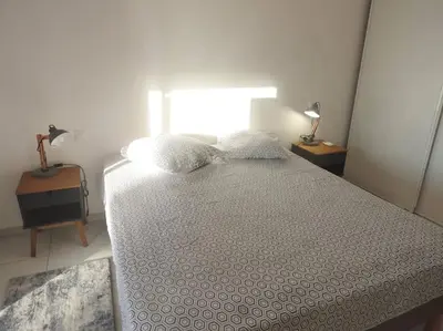a bedroom with a bed with two pillows on it at Splendide T3 neuf au bord de la plage in Propriano