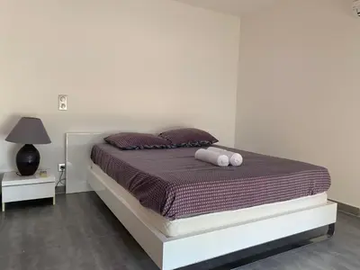 a bed with two pillows on it in a bedroom at Bas de villa - Canella in Sari Solenzara
