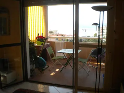 a room with a balcony with a table and chairs at Chambre hôtes Wagram in Ajaccio
