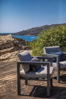 a pair of chairs sitting on top of a beach at Villa Sud Corse 6ch piscine 27m, accès mer in Pianottoli-Caldarello