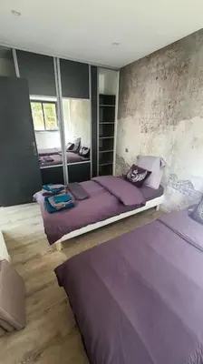 a bedroom with a large purple bed in it at Bergerie entièrement rénovée in Viggianello