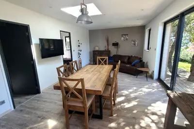 a wooden table and chairs in a living room at Bergerie entièrement rénovée in Viggianello