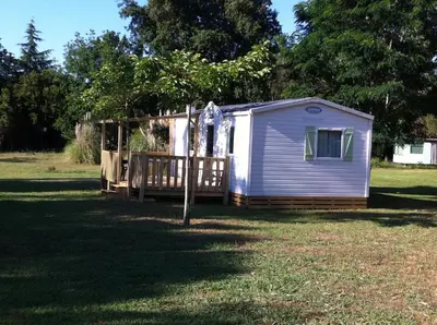 a tiny house in a yard with a fence at Camping Miami plage in Poggio-Mezzana