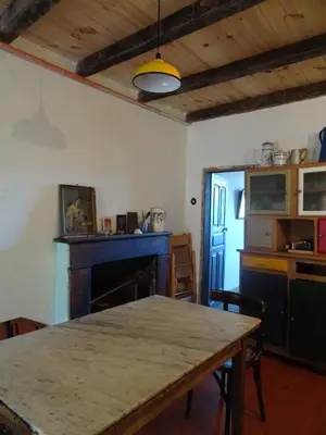 a dining room with a table and a fireplace at Authentique maison de village de Gavignano in Gavignano