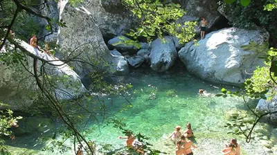 a group of people swimming in a river at Authentique maison de village de Gavignano in Gavignano