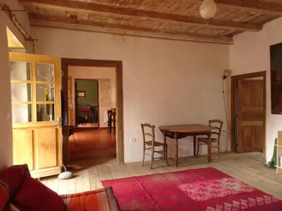 a living room with a table and chairs in a room at Authentique maison de village de Gavignano in Gavignano