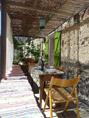 a wooden table and chairs on a patio at Authentique maison de village de Gavignano in Gavignano