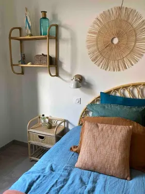 a bedroom with a blue bed and a mirror at Vignarella meublé de tourisme classé 5 étoiles avec terrasse in Piana
