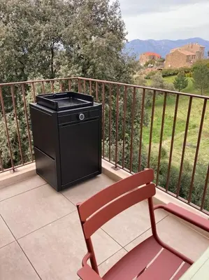 a trash can and a bench on a balcony at Vignarella meublé de tourisme classé 5 étoiles avec terrasse in Piana