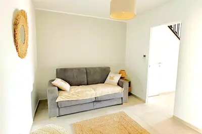 a living room with a gray couch in a room at Duplex Marina Di Cala Rossa in Lecci
