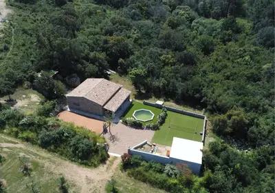 an aerial view of a house with a tennis court at Bergerie U Caseddu in Pianottoli-Caldarello