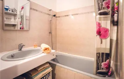 a bathroom with a sink and a tub and a shower at Lovely Apartment In Moriani Plage in Moriani Plage